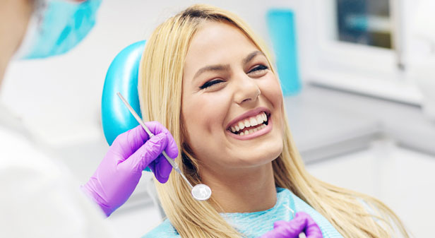 Stock image of a patient on dental chair with smile