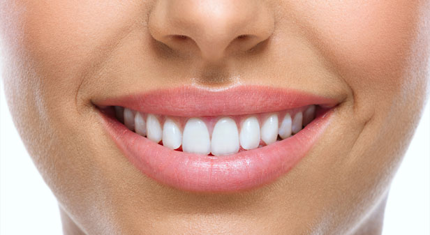Stock image of smiling mouth of a woman