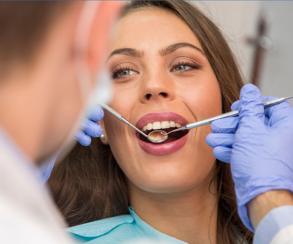 Stock image of a girl being inspected her teeth